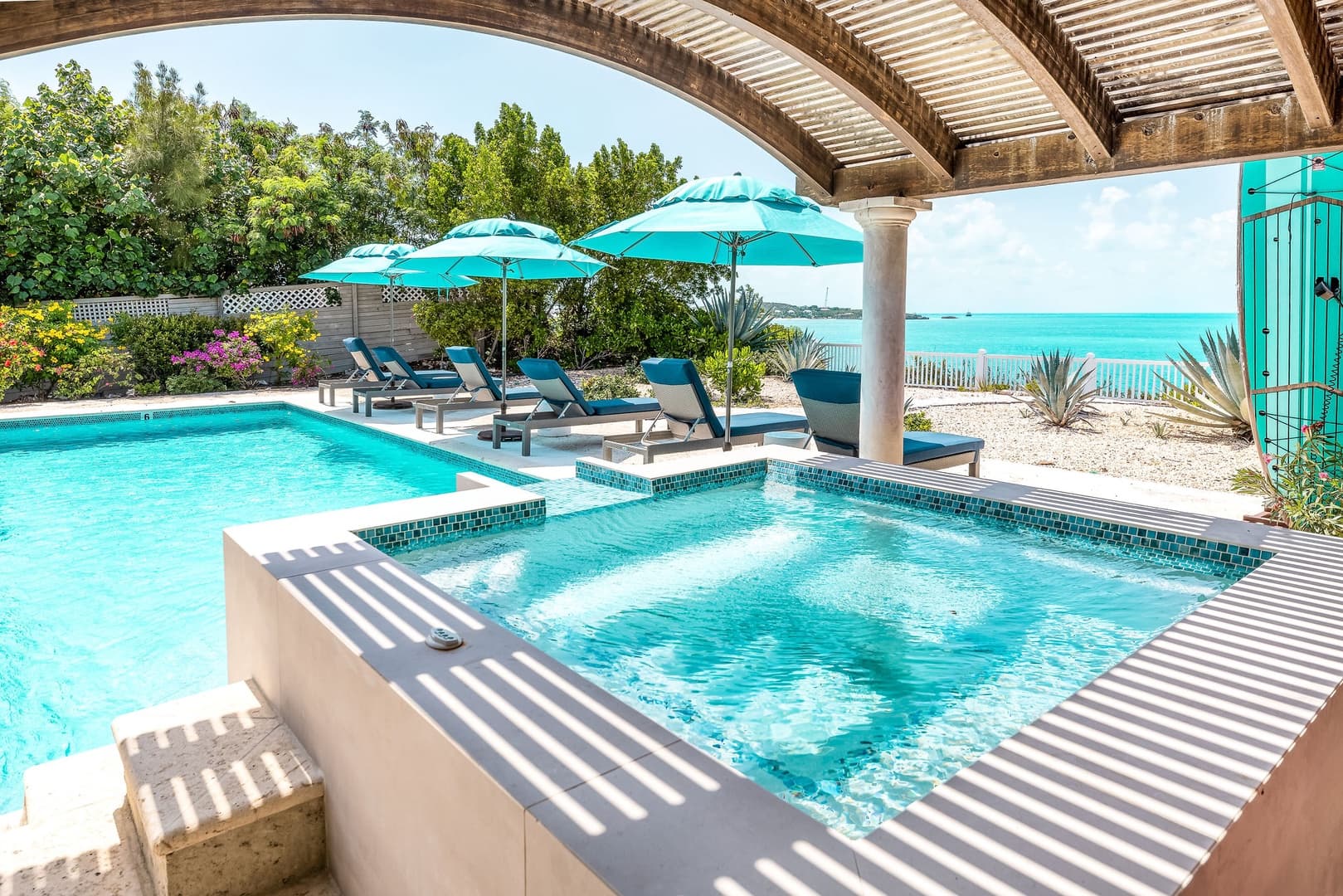Angled view of hot tub, pool and Sapodilla Bay