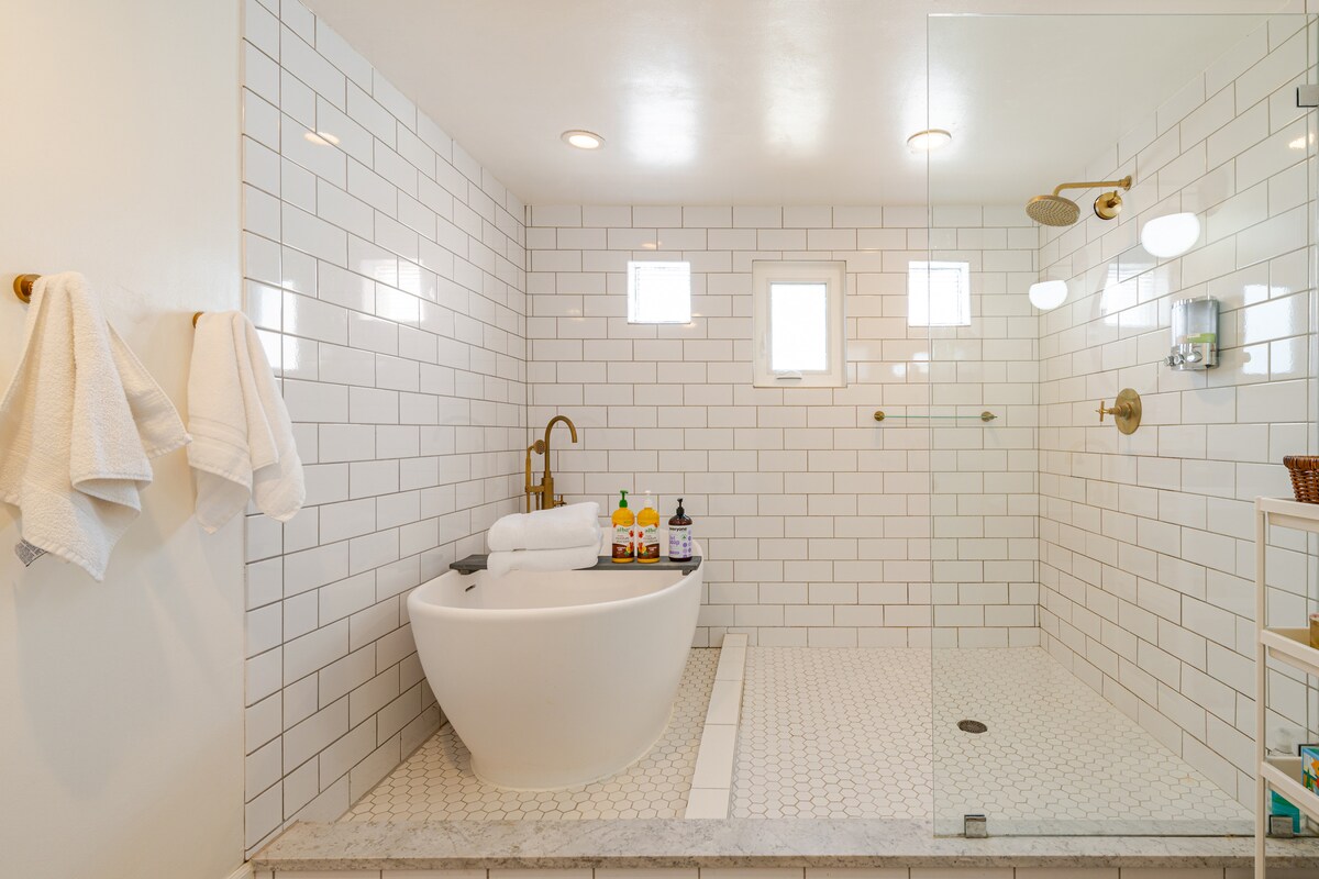 Freestanding tub beside a separate tiled shower