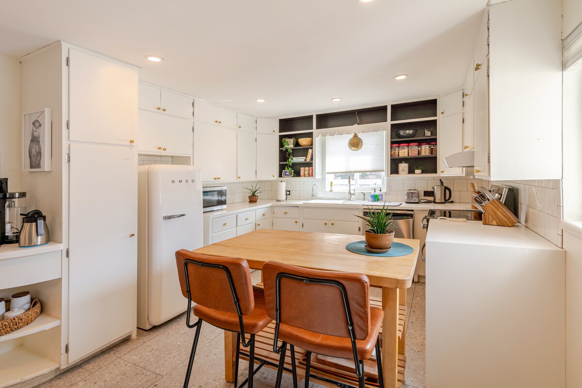Kitchen with SMEG refrigerator and dining table